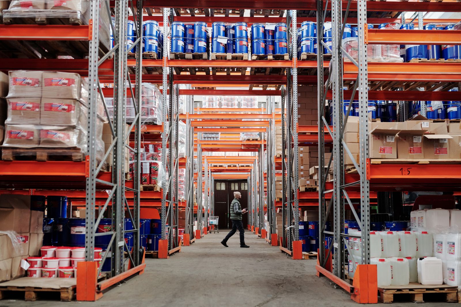 Worker walking through a large industrial warehouse
